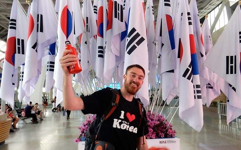 Hagwon teacher in front of South Korean flag