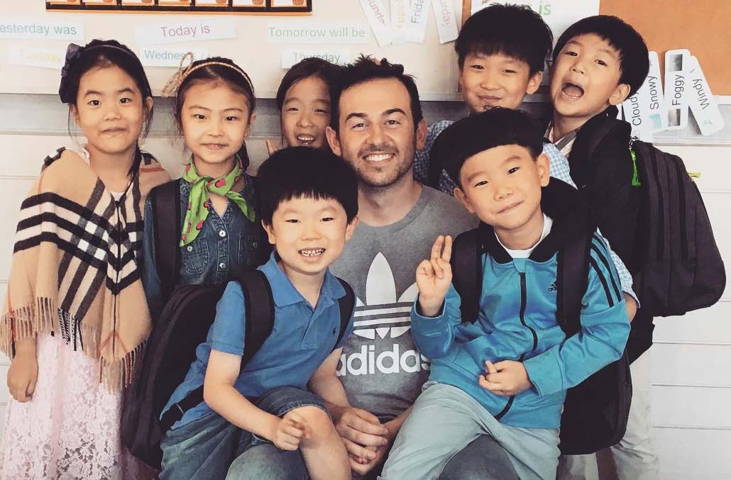 An English teacher and his young TEFL students in Seoul, South Korea