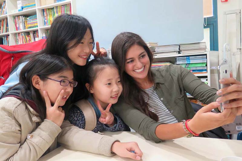 an English teacher in Korea with two TEFL students