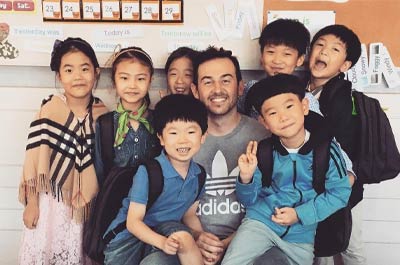 a male young learner teacher and his students